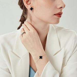Elegant s925 silver jewelry set featuring black clover earrings, bracelet and band ring