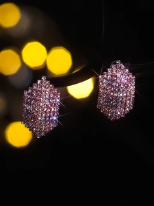 Macro shot of rose pink diamond hex earrings with shimmering crystal pavé detail