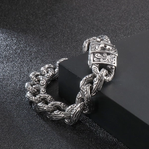Detail of vintage silver skull bracelet with engraved links and secure clasp mechanism