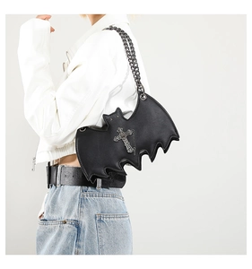 Detailed close-up of a gothic bat-shaped PU leather bag with metal cross and chain strap