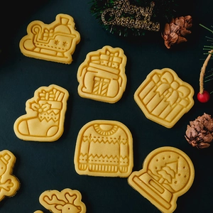 Christmas cookie mold set featuring gingerbread man and reindeer on festive background