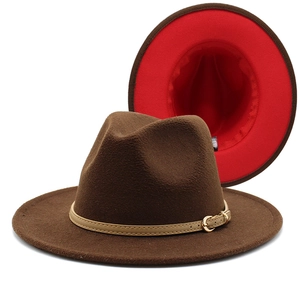 Detail of wool fedora hat featuring two-tone dark brown and red felt with metal buckle strap