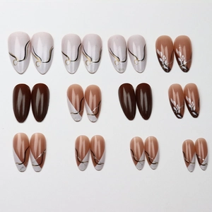 Brown and white long stiletto press-on nails set with floral art and gold accents