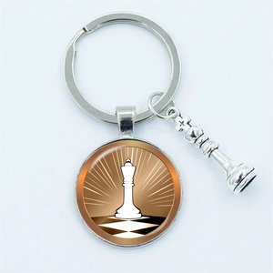 Silver chess keychain featuring a round pendant and a 3D king piece on a clean background