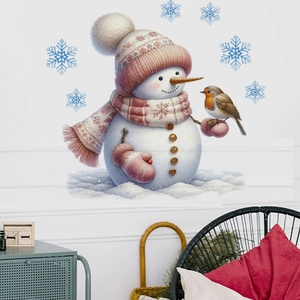 Detail of Christmas snowman wall decal with pink hat and snowflakes on a white wall