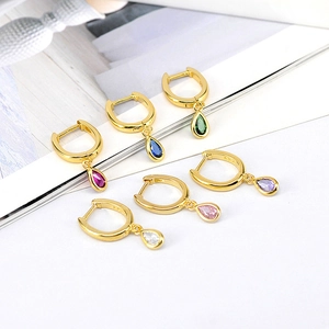 Detailed showcase of six pairs of gold teardrop earrings with colorful zircon stones