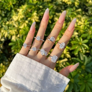 Detail showing various geometric S925 silver rings with pear and oval stones on a hand