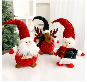 Detailed view of sequined Christmas plush dolls with golden bells and festive fur trim