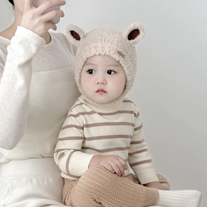 Cute beige plush baby winter earflap hat with bear ears and fashion label detail