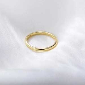 Close-up of minimalist 14K gold plated silver ring with 925 hallmark on silk