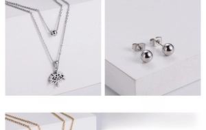 Détail du collier arbre de vie en acier et des boucles d'oreilles boules assorties