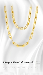 Macro detail of S925 Italy hallmark on polished gold paperclip link necklace