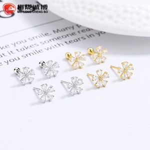 Detailed view of sterling silver flower earrings with zircon stones and screw backings