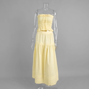 Detail of smocked crop top and high-waisted A-line skirt with hollow lace embroidery