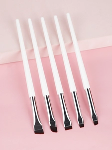 Detailed view of 5-piece eyeliner and eyebrow brush set with white handles and silver ferrules