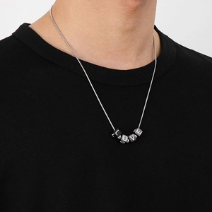 Detail of DIY stainless steel necklace featuring black square LOVE letter cube pendants