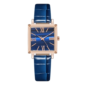 Detail of blue leather strap and rose gold square quartz watch for women with Roman numerals