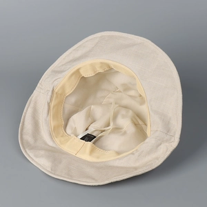Detail of linen sun hat interior with yellow sweatband and adjustable drawstring