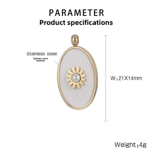 Macro detail of oval stainless steel gold pendant with sunburst motif and pearl inlay