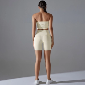 Close-up of seamless light yellow yoga set showing ribbed sports bra and high-waist shorts