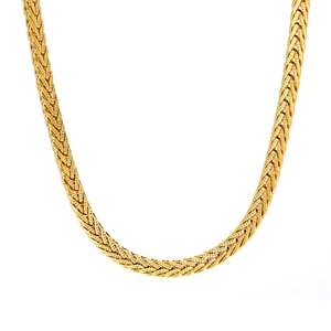 Minimalist gold woven snake chain necklace featuring a flat texture on white background