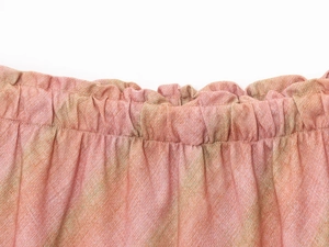 Close-up of elastic pleated waistband on striped linen midi skirt in orange-pink and green