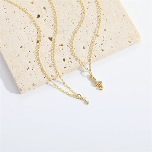 Charming gold musical note pendant necklaces with sparkling crystals on a stone display