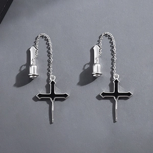 Detail shot of silver S925 cross chain earrings with black enamel coating for men