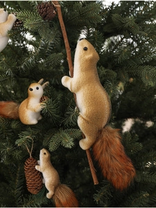 Detailed view of realistic brown foam squirrel ornaments on Christmas tree branches