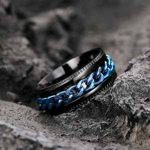 Macro shot of men's spinning ring with black plating and blue chain inlay detail