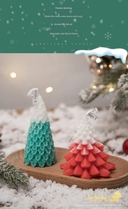Detail of Christmas tree scented candles with leaf texture and snow decorations