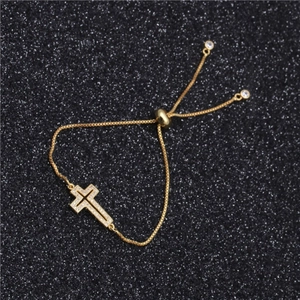 Elegant gold cross bracelet with zircon pavé and adjustable sliding bolo clasp