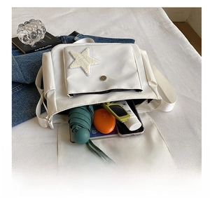 Detailed interior of a white canvas tote bag showing high capacity for daily essentials