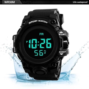 Close-up of waterproof digital sport watch with splashing water and LED display
