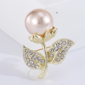 Elegant gold flower brooch with a pink pearl and shimmering rhinestone accents