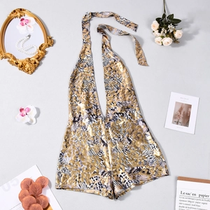 Close-up of golden leopard print backless jumpsuit with metallic luster and halter neckline