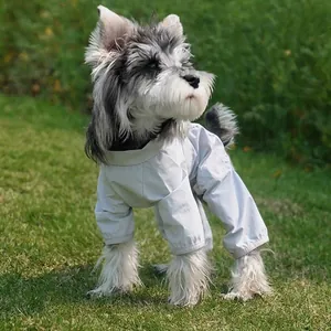 Waterproof light grey dog jumpsuit for outdoor protection on green grass lawn