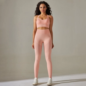 Pink seamless yoga set with racerback sports bra and high-waisted leggings detail