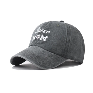 Close-up of Soccer MOM embroidery and football icon on washed dark grey baseball cap