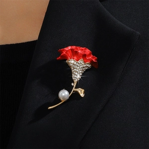Elegant red carnation flower brooch with crystals and pearl on a black suit lapel