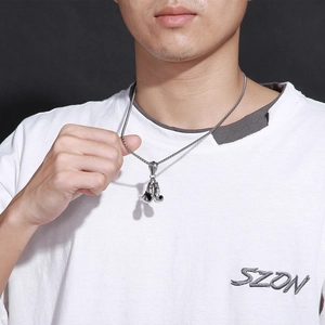 Silver boxing glove pendant necklace in stainless steel worn by a male model