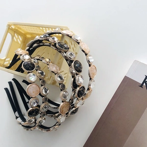 Detail of thin baroque headbands with pearls and crystals on a mini storage basket