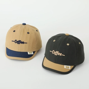 Detail of cotton baseball cap featuring Coffee embroidery and premium twill texture