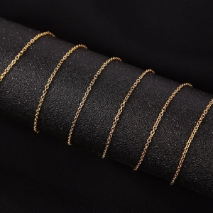 18K gold plated 304 stainless steel flat cross chain necklace displayed on a black stand