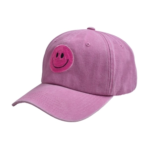 Detailed shot of sequin smiley patch on distressed washed purple cotton baseball cap