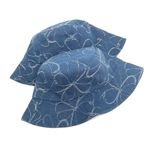 Washed denim bucket hat featuring white floral embroidery in a classic navy blue finish