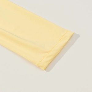 Close-up of bright yellow slim knit dress showing smooth fabric texture and neat stitching