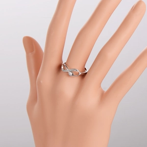 Silver infinity heart ring with pavé crystals on a model hand for a minimalist style