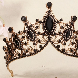 Detailed view of the ornate gold alloy tiara featuring vintage black rhinestones and gems