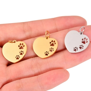Polished stainless steel heart pendants with hollow dog paw cutouts in gold and silver